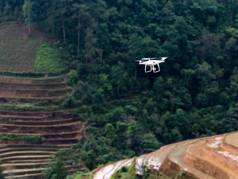 Survey drone collecting LiDAR data over a large property to analyze terrain and identify hidden drainage patterns