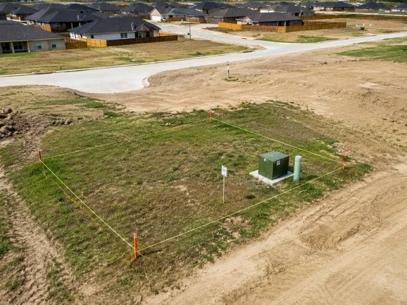 Land surveying markers outlining a future utility tract in a developing Fort Worth Texas subdivision