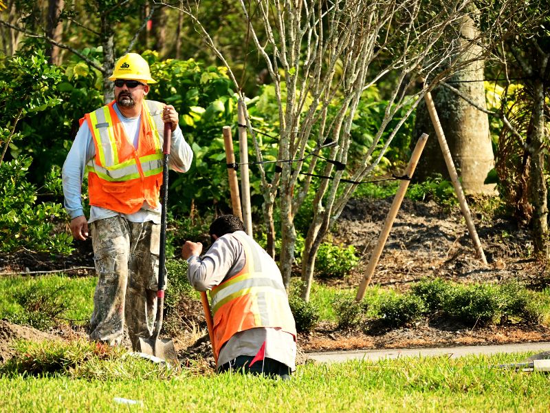 Surveyor checking a yard and property line in the field instead of relying on a GIS parcel map in Fort Worth, Texas.